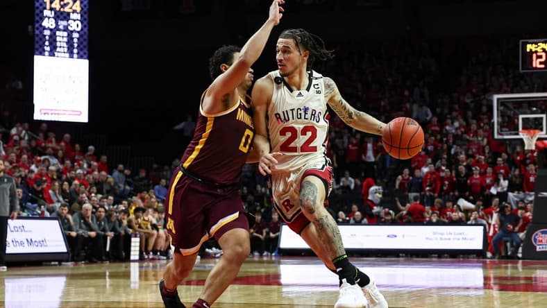 Feb 1, 2023; Piscataway, New Jersey, USA; Rutgers Scarlet Knights guard Caleb McConnell (22) dribbles against Minnesota Golden Gophers guard Taurus Samuels (0) during the second half at Jersey Mike's Arena. Mandatory Credit: Vincent Carchietta-USA TODAY Sports