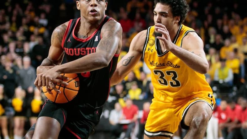 Jan 25, 2023; Wichita, Kansas, USA; Houston Cougars guard Marcus Sasser (0) drives around Wichita State Shockers forward James Rojas (33) during the first half at Charles Koch Arena. Mandatory Credit: William Purnell-USA TODAY Sports