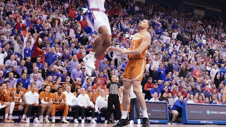 Feb 6, 2023; Lawrence, Kansas, USA; Kansas Jayhawks forward K.J. Adams Jr. (24) dunks the ball as Texas Longhorns forward Dylan Disu (1) looks on during the first half at Allen Fieldhouse. Mandatory Credit: Denny Medley-USA TODAY Sports