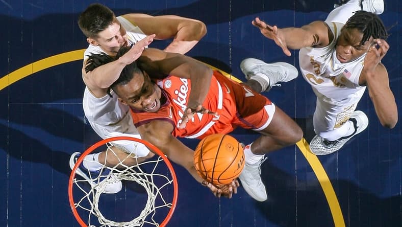 Feb 11, 2023; South Bend, Indiana, USA; Virginia Tech Hokies forward Justyn Mutts (25) goes up for a shot as Notre Dame Fighting Irish forward Nate Laszewski (14) defends in the first half at the Purcell Pavilion. Mandatory Credit: Matt Cashore-USA TODAY Sports