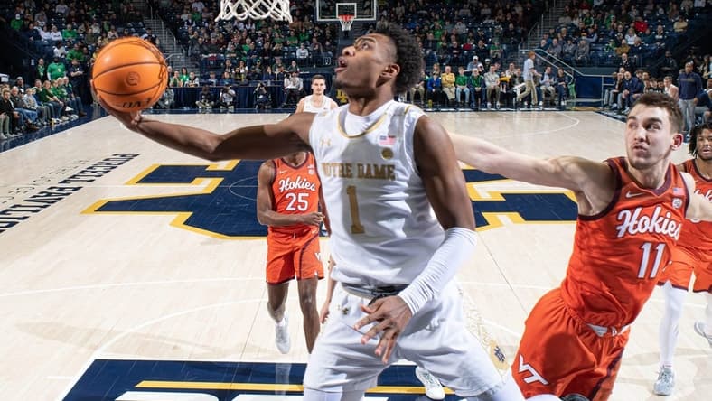 Feb 11, 2023; South Bend, Indiana, USA; Notre Dame Fighting Irish guard JJ Starling (1) goes up for a shot as Virginia Tech Hokies forward John Camden (11) defends in the first half at the Purcell Pavilion. Mandatory Credit: Matt Cashore-USA TODAY Sports