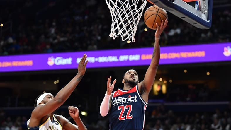 Feb 11, 2023; Washington, District of Columbia, USA; Washington Wizards guard Monte Morris (22) shoots as Indiana Pacers center Myles Turner (33) looks on during the second half at Capital One Arena. Mandatory Credit: Brad Mills-USA TODAY Sports