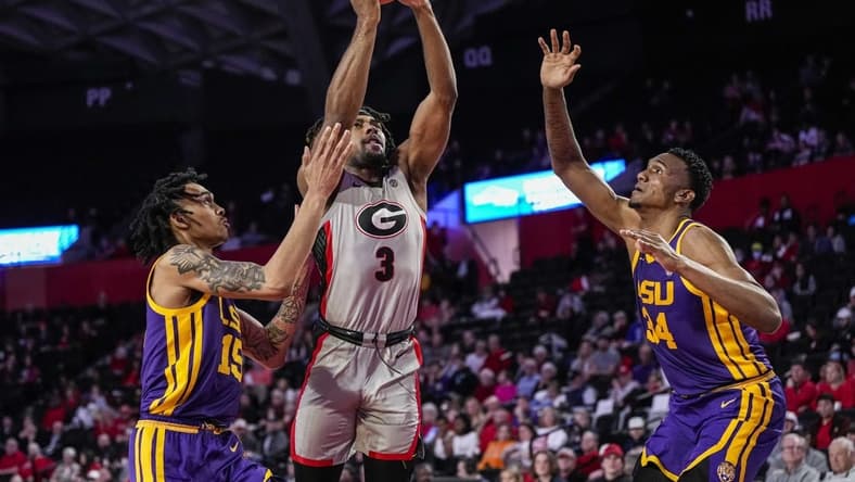 Feb 14, 2023; Athens, Georgia, USA; Georgia Bulldogs guard Kario Oquendo (3) shoots between LSU Tigers forward Tyrell Ward (15) and forward Shawn Phillips (34) during the second half at Stegeman Coliseum. Mandatory Credit: Dale Zanine-USA TODAY Sports