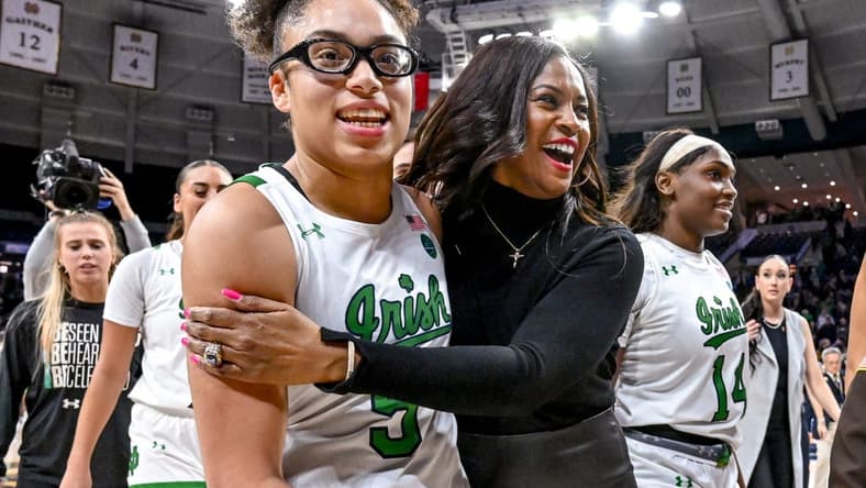 Feb 16, 2023; South Bend, Indiana, USA; Notre Dame Fighting Irish head coach Niele Ivey and guard Olivia Miles (5) leave the court after Notre Dame defeated the Louisville Cardinals 78-76 in overtime. Mandatory Credit: Matt Cashore-USA TODAY Sports