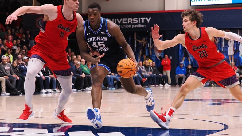 Feb 18, 2023; Moraga, California, USA; BYU Cougars forward Fouseeyni Traore (45) drives in against St. Mary's Gaels center Mitchell Saxen (11) and guard Aidan Mahaney (20) during the second half at University Credit Union Pavilion. Mandatory Credit: Kelley L Cox-USA TODAY Sports