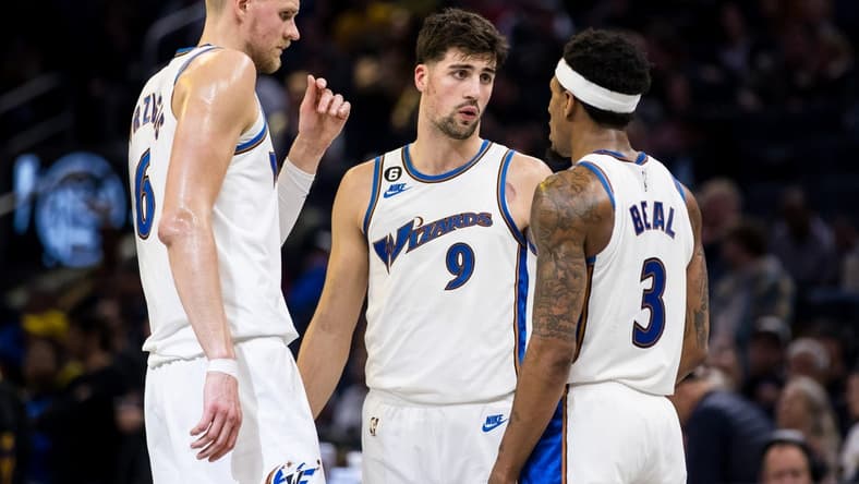 Feb 13, 2023; San Francisco, California, USA; Washington Wizards center Kristaps Porzingis (6) and forward Deni Avdija (9) and guard Bradley Beal (3) talk during the second half of the game against the Golden State Warriors at Chase Center. Mandatory Credit: John Hefti-USA TODAY Sports