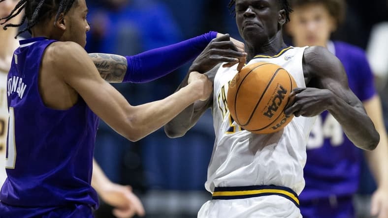 Feb 23, 2023; Berkeley, California, USA; Washington Huskies guard Koren Johnson (0) and California Golden Bears forward Kuany Kuany (13) wrestle for control of a loose ball during the second half at Haas Pavilion. Both players were assessed technical fouls on the play. Mandatory Credit: D. Ross Cameron-USA TODAY Sports