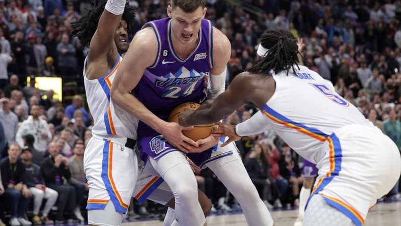 Feb 23, 2023; Salt Lake City, Utah, USA; Utah Jazz center Walker Kessler (24) is fouled by Oklahoma City Thunder guard Luguentz Dort (5) during the second half at Vivint Arena. Mandatory Credit: Chris Nicoll-USA TODAY Sports