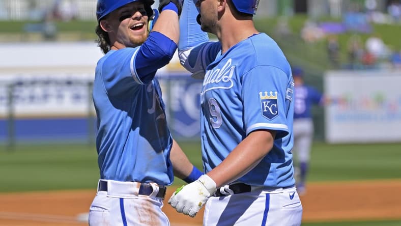 Feb 24, 2023; Surprise, Arizona, USA;  Kansas City Royals first baseman Vinnie Pasquantino (9) is congratulated by shortstop Bobby Witt Jr. (7) after a two run home run in the first inning of a spring training game against the Texas Rangers in Surprise, AZ. Mandatory Credit: Jayne Kamin-Oncea-USA TODAY Sports