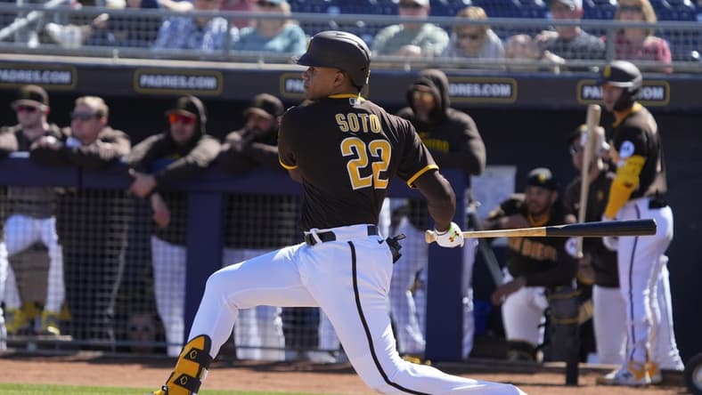 Feb 24, 2023; Peoria, Arizona, USA; San Diego Padres right fielder Juan Soto (22) hits a single against the Seattle Mariners in the first inning at Peoria Sports Complex. Mandatory Credit: Rick Scuteri-USA TODAY Sports