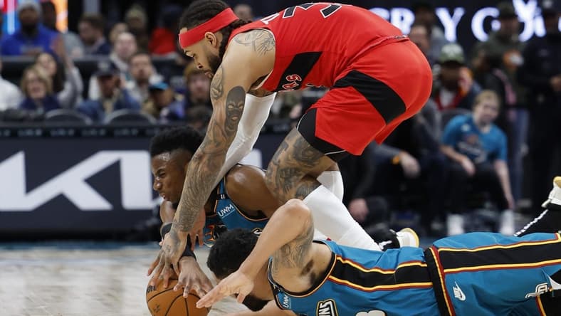 Feb 25, 2023; Detroit, Michigan, USA;Detroit Pistons guard Hamidou Diallo (6) guard Jared Rhoden (8) and Toronto Raptors guard Gary Trent Jr. (33) go after the ball in the second half at Little Caesars Arena. Mandatory Credit: Rick Osentoski-USA TODAY Sports