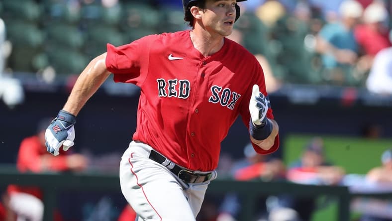 Feb 25, 2023; North Port, Florida, USA; Boston Red Sox first baseman Bobby Dalbec (29) doubles against the Atlanta Braves during the second inning at CoolToday Park. Mandatory Credit: Kim Klement-USA TODAY Sports