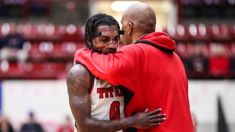 Detroit Mercy guard Antoine Davis (0) hugs head coach Mike Davis after coming off the court during the second half against Wright State at Calihan Hall in Detroit on Saturday, Feb. 25, 2023.
