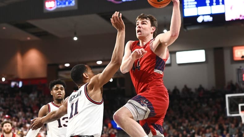 Feb 25, 2023; Spokane, Washington, USA; St. Mary's Gaels guard Alex Ducas (44) shoots the ball against Gonzaga Bulldogs guard Nolan Hickman (11) in the second half at McCarthey Athletic Center. Gonzaga won 77-68. Mandatory Credit: James Snook-USA TODAY Sports