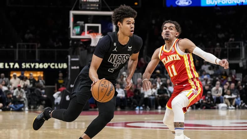 Feb 26, 2023; Atlanta, Georgia, USA; Brooklyn Nets forward Cameron Johnson (2) dribbles past Atlanta Hawks guard Trae Young (11) during the first half at State Farm Arena. Mandatory Credit: Dale Zanine-USA TODAY Sports
