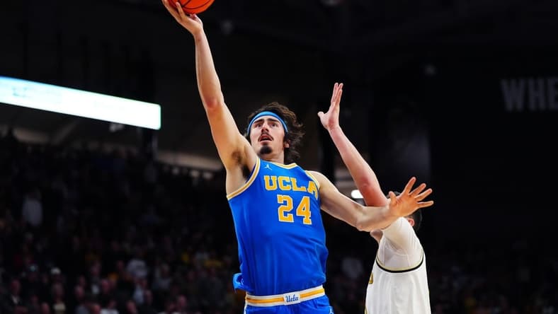 Feb 26, 2023; Boulder, Colorado, USA; UCLA Bruins guard Jaime Jaquez Jr. (24) shoots the ball past Colorado Buffaloes guard Luke O'Brien (0) in the second half at the CU Events Center. Mandatory Credit: Ron Chenoy-USA TODAY Sports