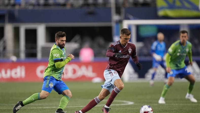 Feb 26, 2023; Seattle, Washington, USA; Colorado Rapids midfielder Cole Bassett (23) moves the ball defended by Seattle Sounders FC midfielder Joao Paulo (6) in the second half at Lumen Field. Mandatory Credit: Kirby Lee-USA TODAY Sports