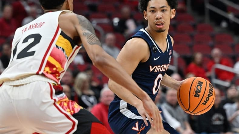 Feb 15, 2023; Louisville, Kentucky, USA; Virginia Cavaliers guard Kihei Clark (0) dribbles against Louisville Cardinals forward JJ Traynor (12) during the first half at KFC Yum! Center. Virginia defeated Louisville 61-58. Mandatory Credit: Jamie Rhodes-USA TODAY Sports