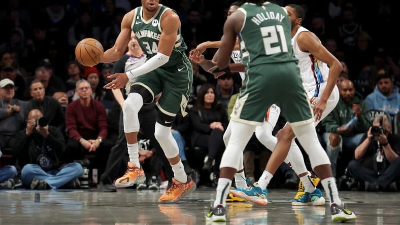 Feb 28, 2023; Brooklyn, New York, USA; Milwaukee Bucks forward Giannis Antetokounmpo (34) looks to pass the ball to guard Jrue Holiday (21) during the first quarter against the Brooklyn Nets at Barclays Center. Mandatory Credit: Brad Penner-USA TODAY Sports