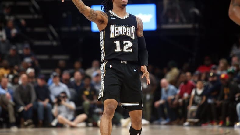 Feb 28, 2023; Memphis, Tennessee, USA; Memphis Grizzlies guard Ja Morant (12) reacts after shooting for three during the first half against the Los Angeles Lakers at FedExForum. Mandatory Credit: Petre Thomas-USA TODAY Sports