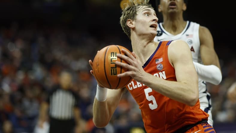 Feb 28, 2023; Charlottesville, Virginia, USA; Clemson Tigers forward Hunter Tyson (5) drives to the basket as Virginia Cavaliers guard Ryan Dunn (13) chases in the first half at John Paul Jones Arena. Mandatory Credit: Geoff Burke-USA TODAY Sports