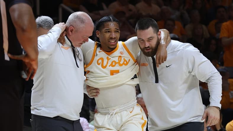 Feb 28, 2023; Knoxville, Tennessee, USA; Tennessee Volunteers guard Zakai Zeigler (5) is helped off the court after an injury during the first half against the Arkansas Razorbacks at Thompson-Boling Arena. Mandatory Credit: Randy Sartin-USA TODAY Sports