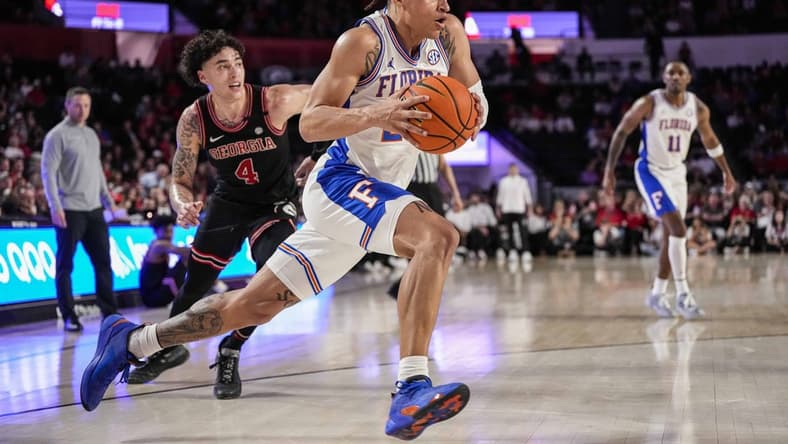 Feb 28, 2023; Athens, Georgia, USA; Florida Gators guard Riley Kugel (24) dribbles past Georgia Bulldogs guard Jusaun Holt (4) during the first half at Stegeman Coliseum. Mandatory Credit: Dale Zanine-USA TODAY Sports