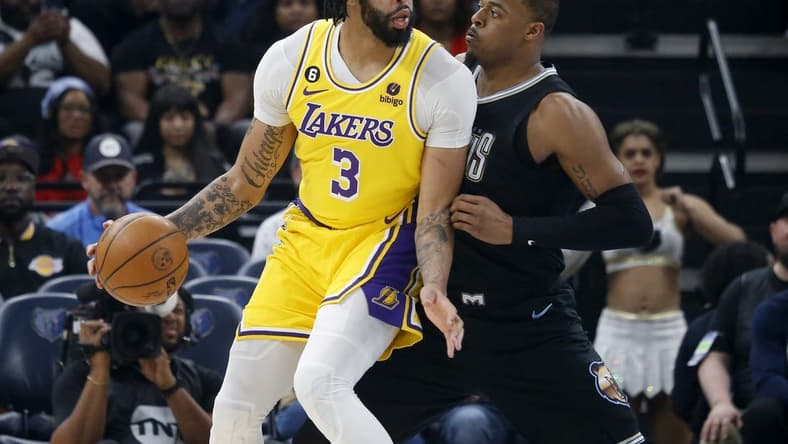 Feb 28, 2023; Memphis, Tennessee, USA; Los Angeles Lakers forward Anthony Davis (3) handles the ball as Memphis Grizzlies forward Xavier Tillman (2) defends during the first half at FedExForum. Mandatory Credit: Petre Thomas-USA TODAY Sports