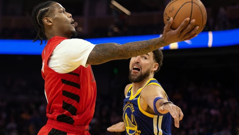 Feb 28, 2023; San Francisco, California, USA; Portland Trail Blazers forward Cam Reddish (5) shoots around Golden State Warriors guard Klay Thompson (11) during the second quarter at Chase Center. Mandatory Credit: D. Ross Cameron-USA TODAY Sports