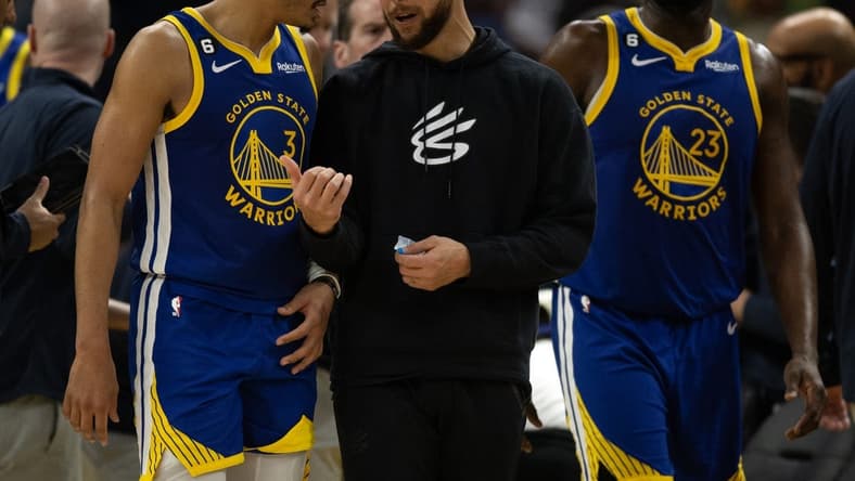 Feb 28, 2023; San Francisco, California, USA; Golden State Warriors guard Jordan Poole (3) confers with injured teammate Stephen Curry during a timeout in the fourth quarter against the Portland Trail Blazers at Chase Center. Mandatory Credit: D. Ross Cameron-USA TODAY Sports
