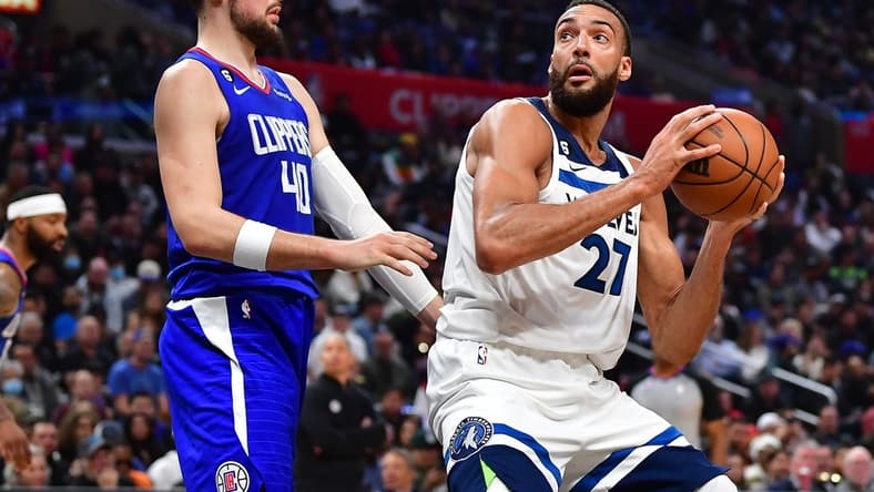 Feb 28, 2023; Los Angeles, California, USA; Minnesota Timberwolves center Rudy Gobert (27) moves to the basket against Los Angeles Clippers center Ivica Zubac (40) during the second half at Crypto.com Arena. Mandatory Credit: Gary A. Vasquez-USA TODAY Sports