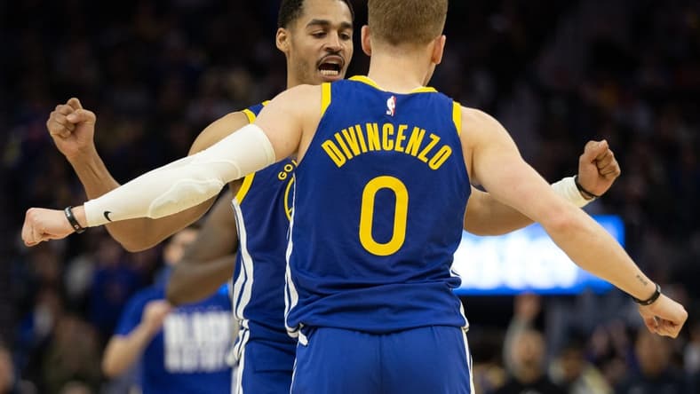 Feb 28, 2023; San Francisco, California, USA; Golden State Warriors guard Jordan Poole (left) and teammate Donte DiVincenzo (0) celebrate during the fourth quarter against the Portland Trail Blazers at Chase Center. Mandatory Credit: D. Ross Cameron-USA TODAY Sports