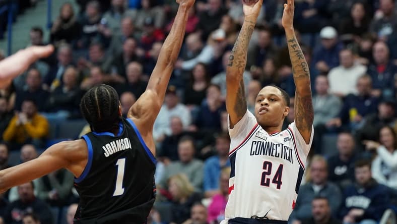 Mar 1, 2023; Hartford, Connecticut, USA; UConn Huskies guard Jordan Hawkins (24) shoots against DePaul Blue Demons forward Javan Johnson (1) in the first half at XL Center. Mandatory Credit: David Butler II-USA TODAY Sports