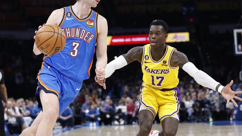 Mar 1, 2023; Oklahoma City, Oklahoma, USA; Oklahoma City Thunder guard Josh Giddey (3) dribbles the ball around Los Angeles Lakers guard Dennis Schroder (17) during the second quarter at Paycom Center. Mandatory Credit: Alonzo Adams-USA TODAY Sports