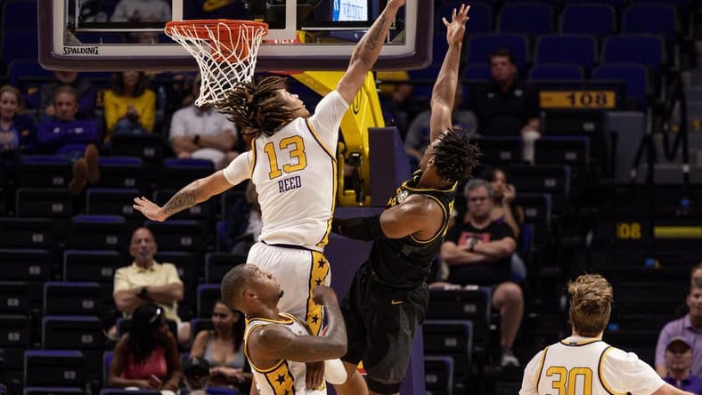 Mar 1, 2023; Baton Rouge, Louisiana, USA; LSU Tigers forward Jalen Reed (13) blocks a shot against Missouri Tigers guard DeAndre Gholston (4) during the first half at Pete Maravich Assembly Center. Mandatory Credit: Stephen Lew-USA TODAY Sports