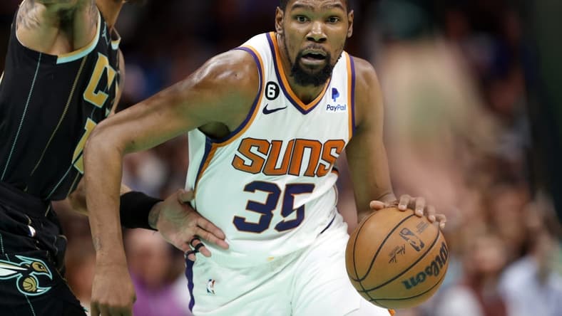 Mar 1, 2023; Charlotte, North Carolina, USA; Phoenix Suns forward Kevin Durant (35) drives to the basket past Charlotte Hornets guard Kelly Oubre Jr. (12) during the second half at Spectrum Center. Mandatory Credit: Brian Westerholt-USA TODAY Sports