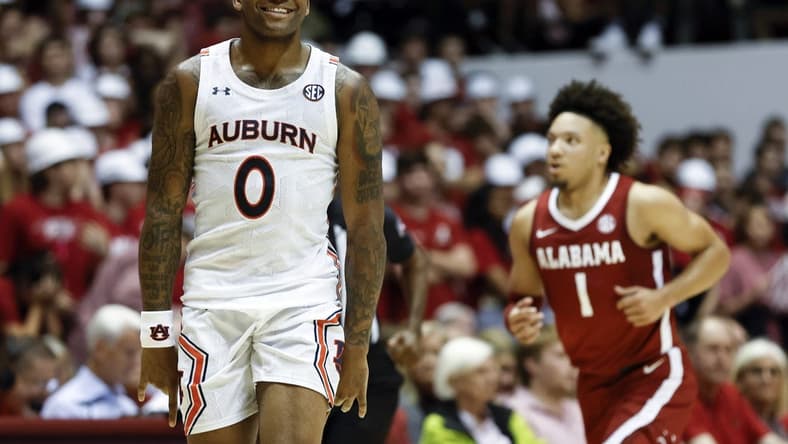 Mar 1, 2023; Tuscaloosa, Alabama, USA; Auburn Tigers guard K.D. Johnson (0) reacts after making a three pointer against the Alabama Crimson Tide during the second half of an NCAA basketball game at Coleman Coliseum. Mandatory Credit: Butch Dill-USA TODAY Sports