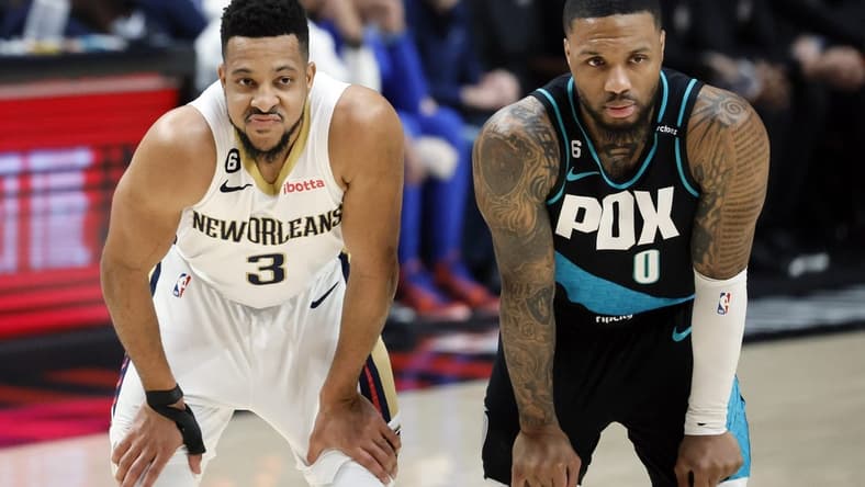 Mar 1, 2023; Portland, Oregon, USA; New Orleans Pelicans shooting guard CJ McCollum (3) and Portland Trail Blazers point guard Damian Lillard (0) look on during the first half at Moda Center. Mandatory Credit: Soobum Im-USA TODAY Sports