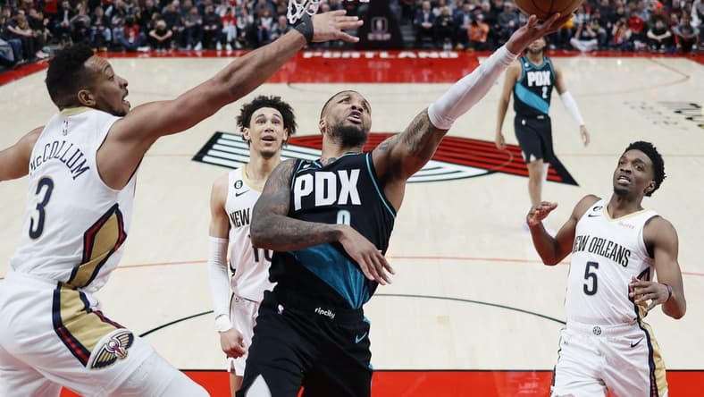 Mar 1, 2023; Portland, Oregon, USA; Portland Trail Blazers point guard Damian Lillard (0) shoots the ball against New Orleans Pelicans shooting guard CJ McCollum (3) during the first half at Moda Center. Mandatory Credit: Soobum Im-USA TODAY Sports