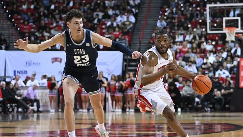 Mar 1, 2023; Las Vegas, Nevada, USA; Utah State Aggies forward Taylor Funk (23) defends against UNLV Rebels guard EJ Harkless (55) in the first half at Thomas & Mack Center. Mandatory Credit: Candice Ward-USA TODAY Sports