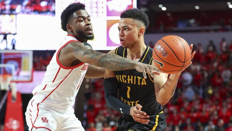 Mar 2, 2023; Houston, Texas, USA; Wichita State Shockers guard Xavier Bell (1) controls the ball as Houston Cougars guard Jamal Shead (1) defends during the first half at Fertitta Center. Mandatory Credit: Troy Taormina-USA TODAY Sports