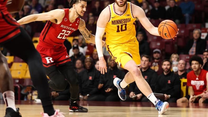 Mar 2, 2023; Minneapolis, Minnesota, USA; Minnesota Golden Gophers forward Jamison Battle (10) drives to the basket while Rutgers Scarlet Knights guard Caleb McConnell (22) defends during the first half at Williams Arena. Mandatory Credit: Matt Krohn-USA TODAY Sports