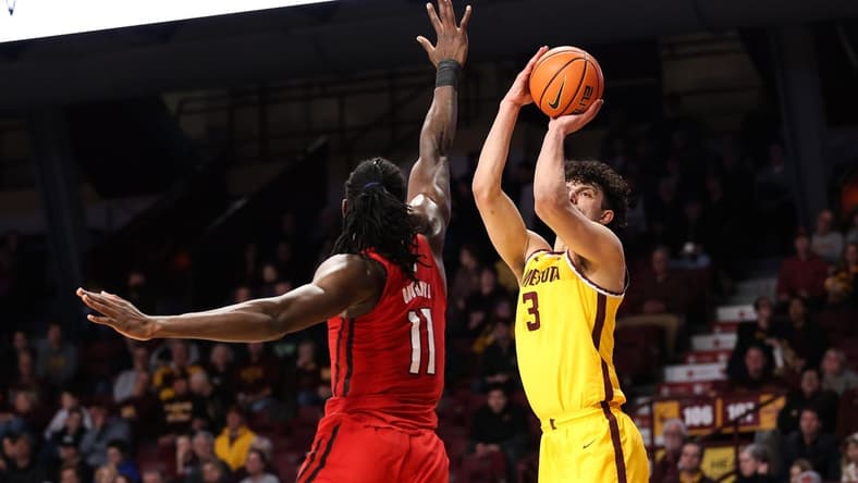 Mar 2, 2023; Minneapolis, Minnesota, USA; Minnesota Golden Gophers forward Dawson Garcia (3) shoots while Rutgers Scarlet Knights center Clifford Omoruyi (11) defends during the first half at Williams Arena. Mandatory Credit: Matt Krohn-USA TODAY Sports
