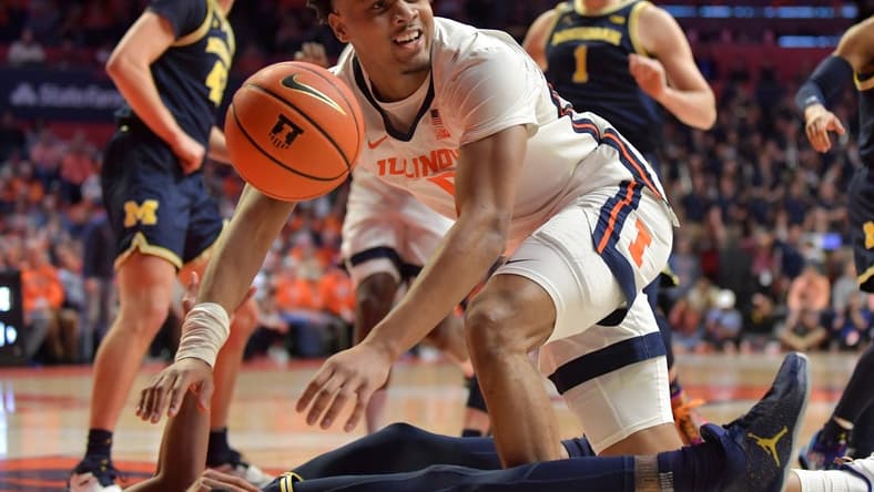 Mar 2, 2023; Champaign, Illinois, USA; Illinois Fighting Illini guard Terrence Shannon Jr. (0) looks for the call as he drives the ball against Michigan Wolverines guard Kobe Bufkin (2) during the first half at State Farm Center. Mandatory Credit: Ron Johnson-USA TODAY Sports