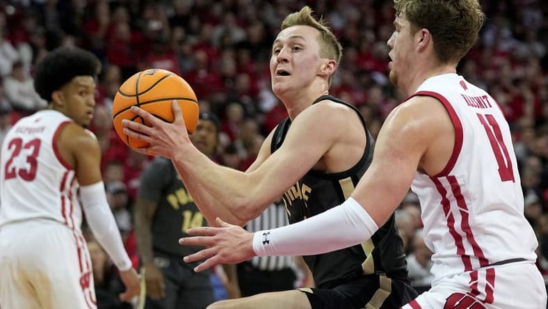 Mar. 2, 2023; Milwaukee, Wisconsin, USA; Purdue Boilermakers guard Fletcher Loyer (2) drives on Wisconsin Badgers guard Max Klesmit (11) during the first half of their game at Kohl Center. Mandatory Credit: Mark Hoffman-USA TODAY Sports