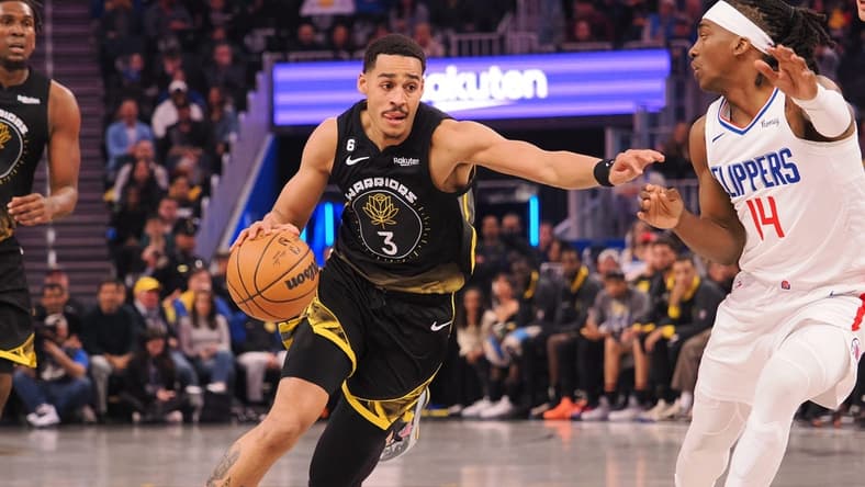 Mar 2, 2023; San Francisco, California, USA; Golden State Warriors guard Jordan Poole (3) drives in against Los Angeles Clippers shooting guard Terance Mann (14) during the first quarter at Chase Center. Mandatory Credit: Kelley L Cox-USA TODAY Sports