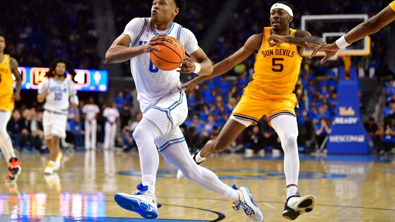 Mar 2, 2023; Los Angeles, California, USA; UCLA Bruins guard Jaylen Clark (0) moves to the basket ahead of Arizona State Sun Devils forward Jamiya Neal (5) during the second half at Pauley Pavilion. Mandatory Credit: Gary A. Vasquez-USA TODAY Sports