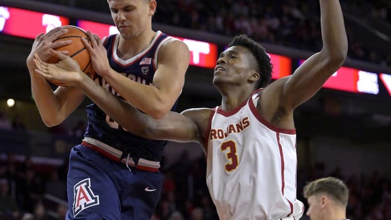Mar 2, 2023; Los Angeles, California, USA; Arizona Wildcats guard Kerr Kriisa (25) beats USC Trojans forward Vincent Iwuchukwu (3) to a rebound in the first half at Galen Center. Mandatory Credit: Jayne Kamin-Oncea-USA TODAY Sports