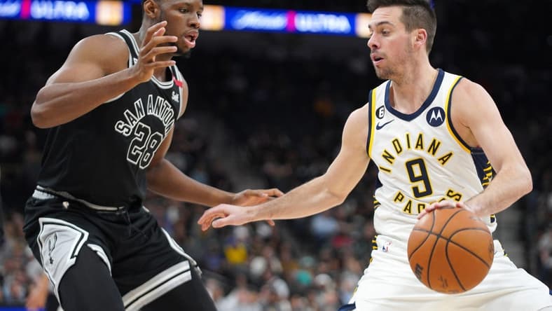 Mar 2, 2023; San Antonio, Texas, USA; Indiana Pacers guard T.J. McConnell (9) dribble against San Antonio Spurs center Charles Bassey (28) during the third quarter in a 110-99 Spurs win at AT&T Center. Mandatory Credit: Dustin Safranek-USA TODAY Sports