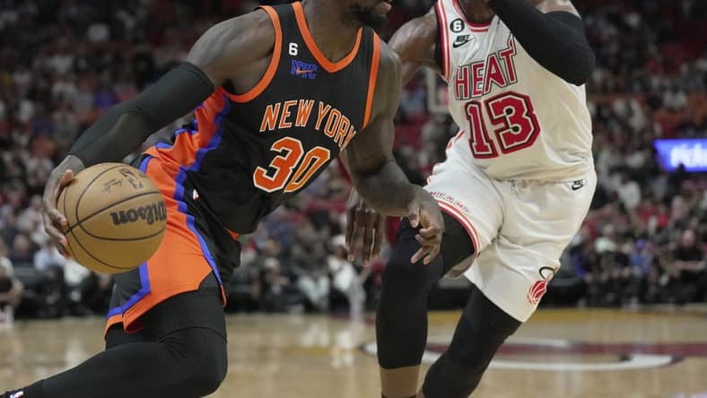 Mar 3, 2023; Miami, Florida, USA; New York Knicks forward Julius Randle (30) drives past Miami Heat center Bam Adebayo (13) during the first half at Miami-Dade Arena. Mandatory Credit: Jim Rassol-USA TODAY Sports